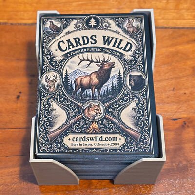 A Cards Wild deck standing in its card holder. The box front carries an elk engraving and the line Born in Jasper, Colorado 2007.