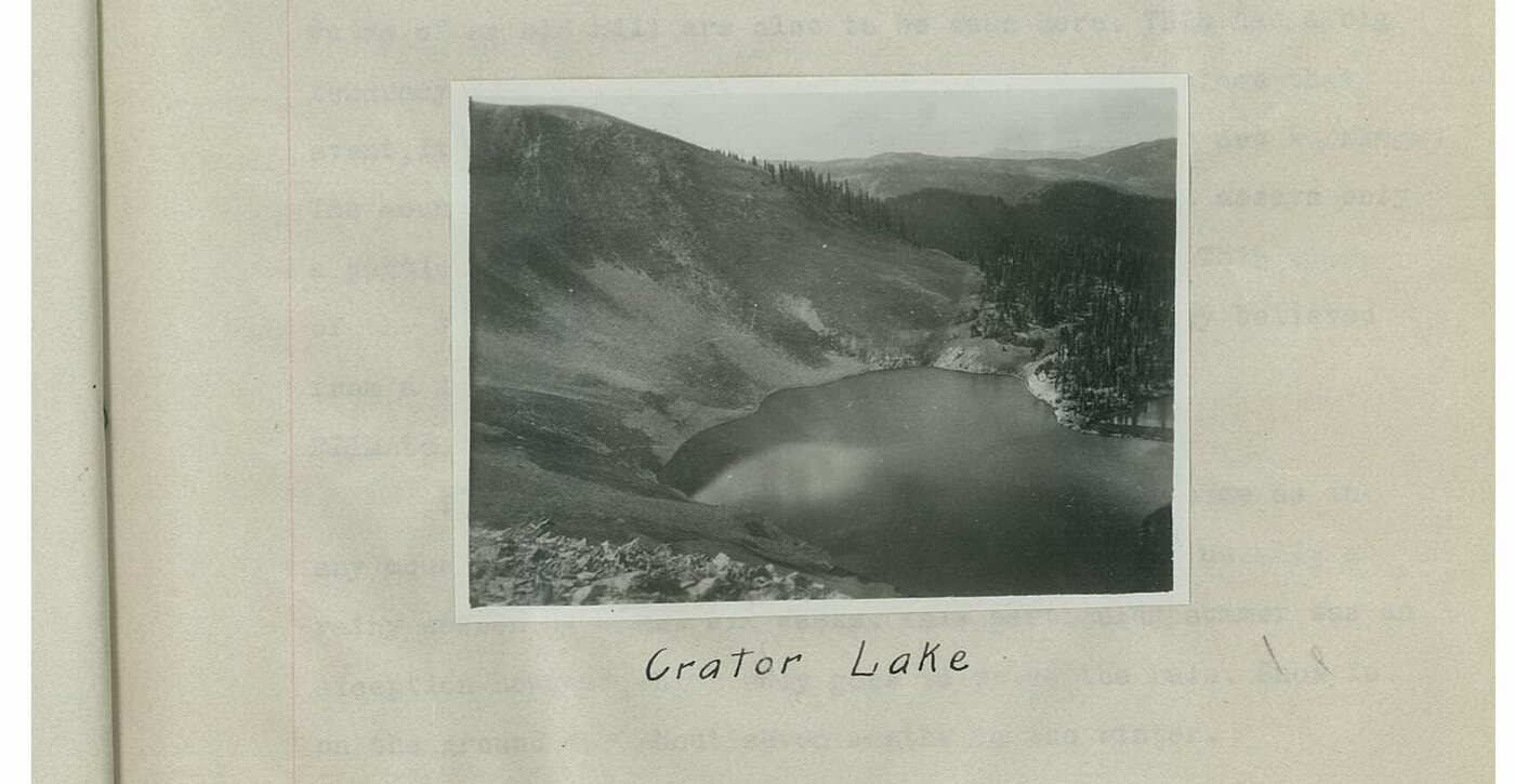 Black and white photograph mounted on a page, hand captioned: Crater Lake